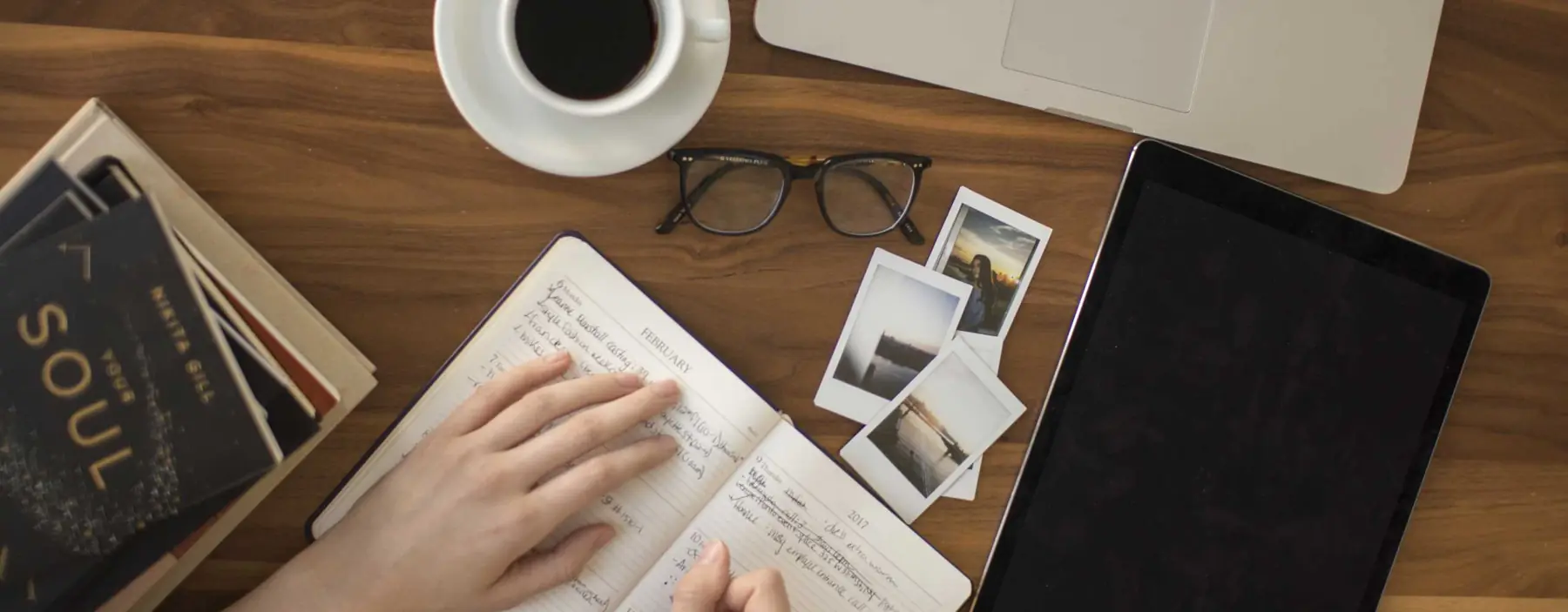 Business desk with notebook, documents, tablet and coffee